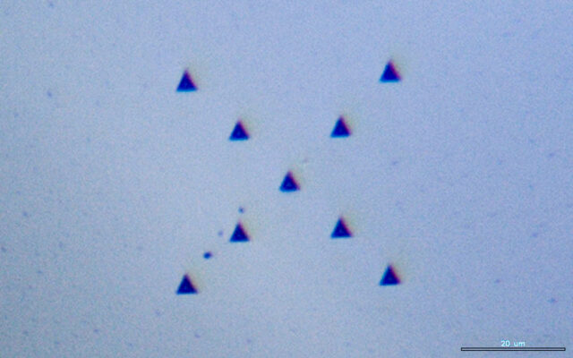 Nine Nanoindentation Imprints Under Optical Microscope Nine nanoindentation imprints viewed under an optical microscope for hardness and mechanical property analysis.