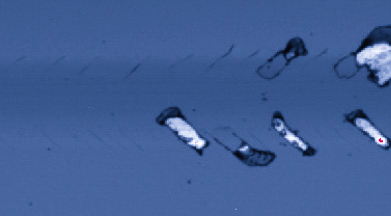 3D optical image of scratch track showing first delamination stage with coating fragments detaching from substrate surface