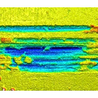 Fretting wear damage on a metal component caused by repeated micro-motion under cyclic loading.