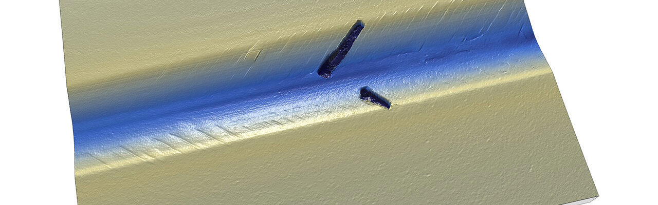 Scratch test showing the critical load for failure of a diamond-like carbon (DLC) coating.