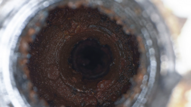 Tribocorrosion testing of a corroded steel pipe to evaluate the combined effects of wear and corrosion on material durability.