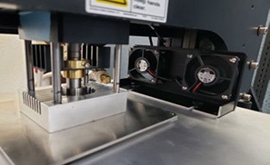 Hot Hardness Tester Thermal Management System with Active Cooling Hot hardness tester thermal management system showing heating stage and dual cooling fans for temperature control